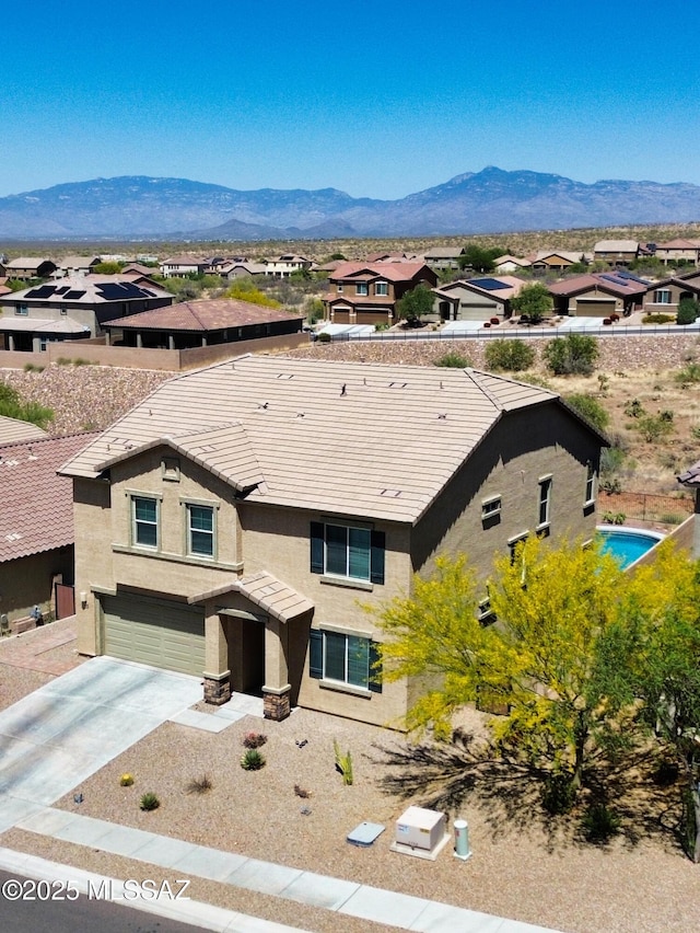 drone / aerial view featuring a residential view and a mountain view