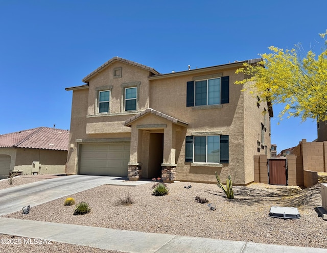 traditional-style home featuring a garage, stucco siding, driveway, and a gate