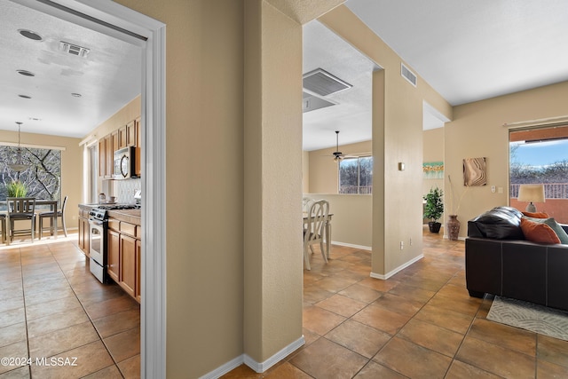 13792 E Langtry Ln, Tucson, AZ 85747 - hall with baseboards, tile patterned flooring, and visible vents