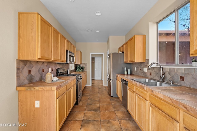 13792 E Langtry Ln, Tucson, AZ 85747 - kitchen featuring tasteful backsplash, tile countertops, a sink, and stainless steel appliances