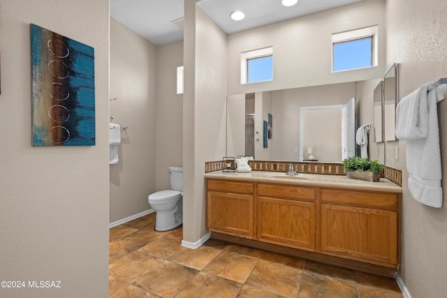 13792 E Langtry Ln, Tucson, AZ 85747 - bathroom featuring toilet, vanity, and baseboards