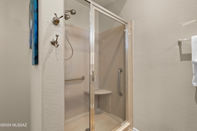 13792 E Langtry Ln, Tucson, AZ 85747 - bathroom featuring a shower stall and a textured wall