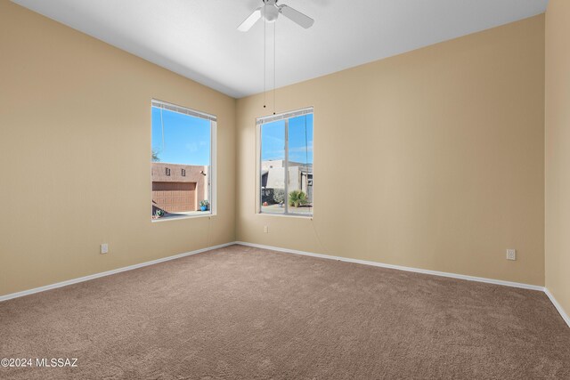 13792 E Langtry Ln, Tucson, AZ 85747 - spare room featuring baseboards, carpet flooring, and ceiling fan
