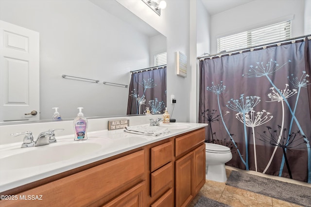 full bath with tile patterned floors, a sink, double vanity, and toilet