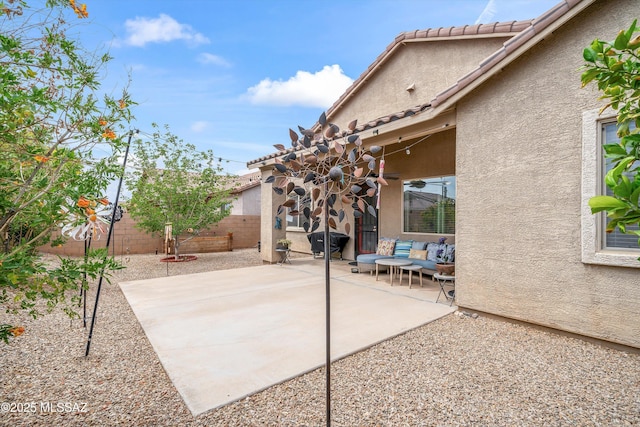 view of patio / terrace with a fenced backyard, a ceiling fan, and an outdoor hangout area