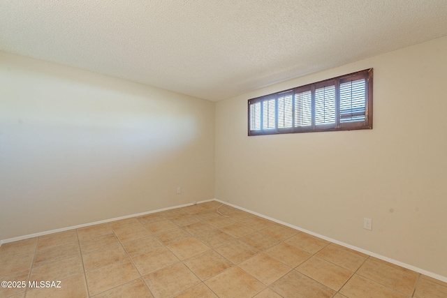 7617 E Morelos Pl, Tucson, AZ 85710 - unfurnished room with light tile patterned floors, a textured ceiling, and baseboards