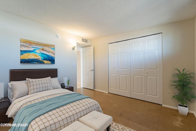 7617 E Morelos Pl, Tucson, AZ 85710 - bedroom with baseboards, a closet, and a textured ceiling