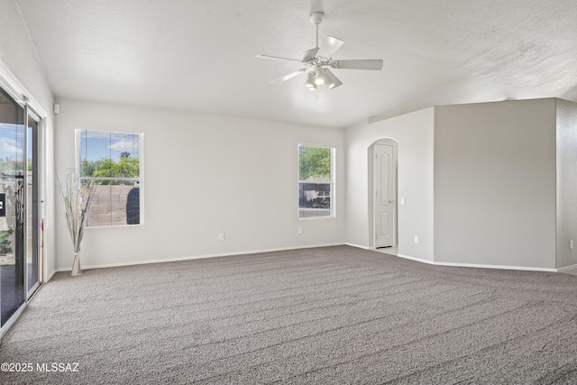 2253 W Catalina View Dr, Tucson, AZ 85742 - carpeted spare room with ceiling fan, a wealth of natural light, baseboards, and arched walkways