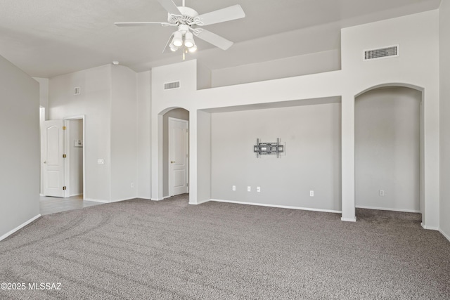 2253 W Catalina View Dr, Tucson, AZ 85742 - carpeted spare room with ceiling fan, visible vents, arched walkways, and high vaulted ceiling
