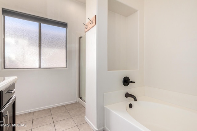 full bath with vanity, tile patterned floors, baseboards, an enclosed shower, and a garden tub