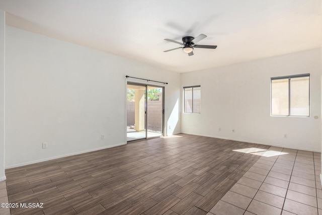 unfurnished room featuring baseboards, a ceiling fan, and wood finished floors