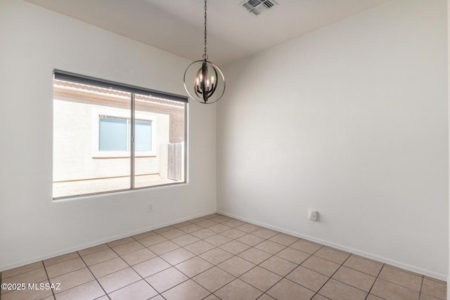 spare room featuring an inviting chandelier, light tile patterned floors, baseboards, and visible vents