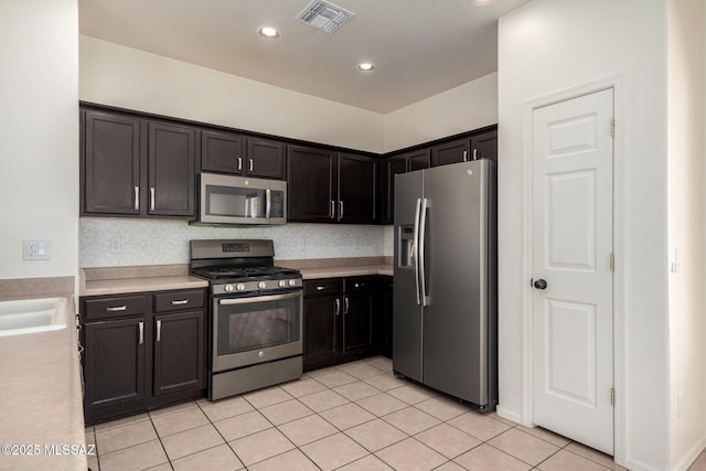 kitchen featuring light countertops, stainless steel appliances, light tile patterned flooring, and visible vents