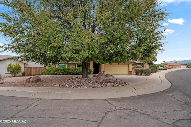 obstructed view of property with stucco siding, a garage, fence, and concrete driveway