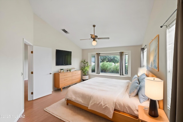 bedroom with high vaulted ceiling, ceiling fan, light wood finished floors, and visible vents