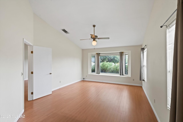 spare room featuring ceiling fan, baseboards, wood finished floors, vaulted ceiling, and visible vents