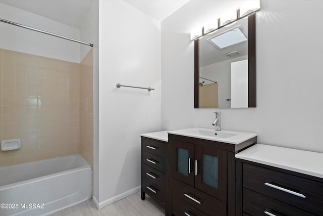 bathroom with baseboards, bathing tub / shower combination, and vanity