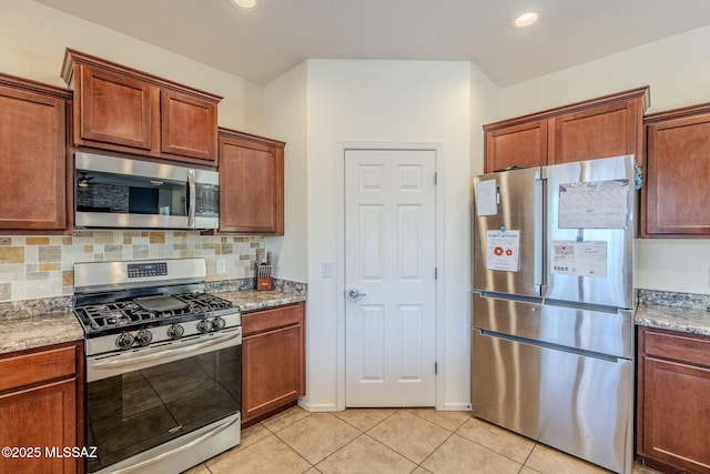 kitchen featuring light stone counters, recessed lighting, backsplash, light tile patterned flooring, and appliances with stainless steel finishes