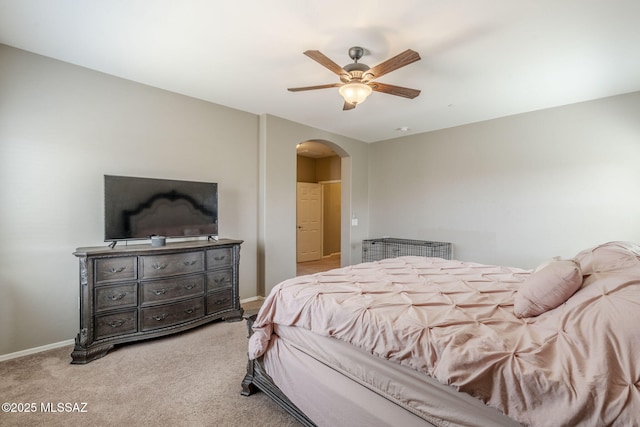 bedroom with carpet flooring, baseboards, a ceiling fan, and arched walkways