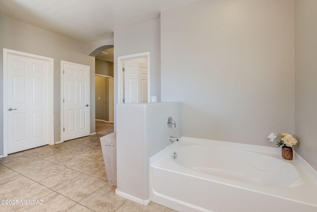 full bath with tile patterned floors and a bath