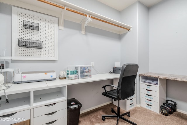 carpeted home office featuring baseboards