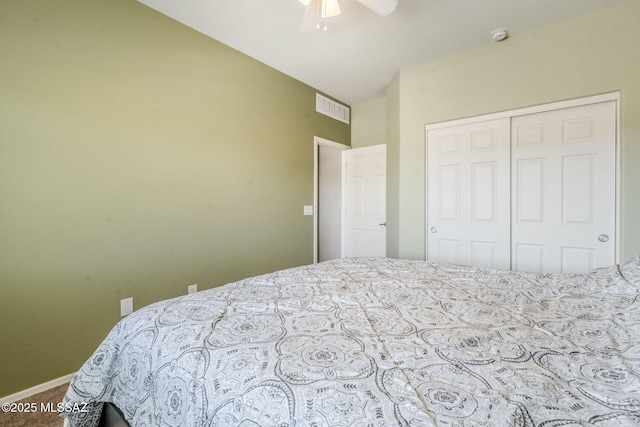 carpeted bedroom with visible vents, a closet, baseboards, and ceiling fan