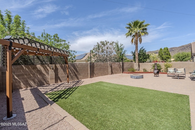view of yard with a pergola, a patio, a fenced backyard, and a mountain view