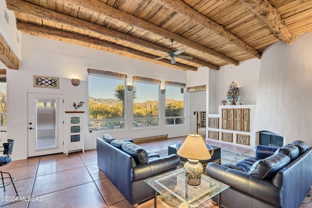 living room with beamed ceiling, ceiling fan, tile patterned flooring, and wood ceiling