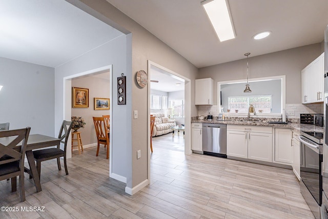649 W Via, San Mateo, Green Valley, AZ 85614 - kitchen with white cabinetry, decorative backsplash, light stone counters, and appliances with stainless steel finishes