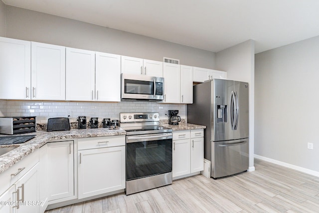 649 W Via, San Mateo, Green Valley, AZ 85614 - kitchen featuring white cabinetry, visible vents, backsplash, and appliances with stainless steel finishes