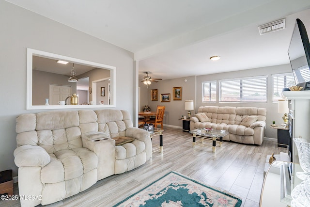 649 W Via, San Mateo, Green Valley, AZ 85614 - living area with visible vents, baseboards, a ceiling fan, and wood finished floors