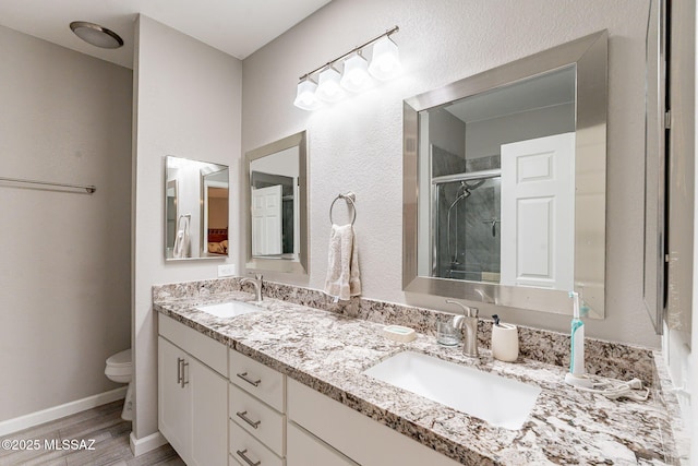 649 W Via, San Mateo, Green Valley, AZ 85614 - bathroom featuring toilet, a sink, a stall shower, and wood finished floors