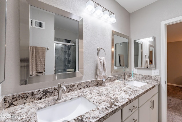 649 W Via, San Mateo, Green Valley, AZ 85614 - full bath featuring a sink, visible vents, double vanity, and a stall shower