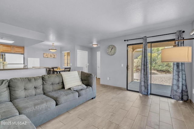 101 S Players Club Dr Unit 12103, Tucson, AZ 85745 - living room with baseboards, wood tiled floor, and a textured ceiling