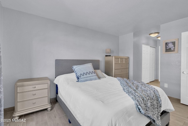 101 S Players Club Dr Unit 12103, Tucson, AZ 85745 - bedroom featuring a closet, baseboards, and wood tiled floor