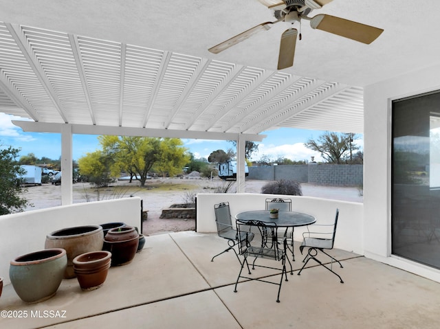 view of patio featuring outdoor dining area, a pergola, and ceiling fan