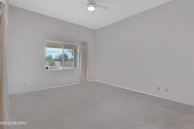 carpeted empty room featuring baseboards and ceiling fan