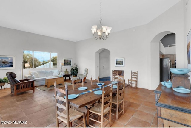dining room featuring an inviting chandelier and arched walkways