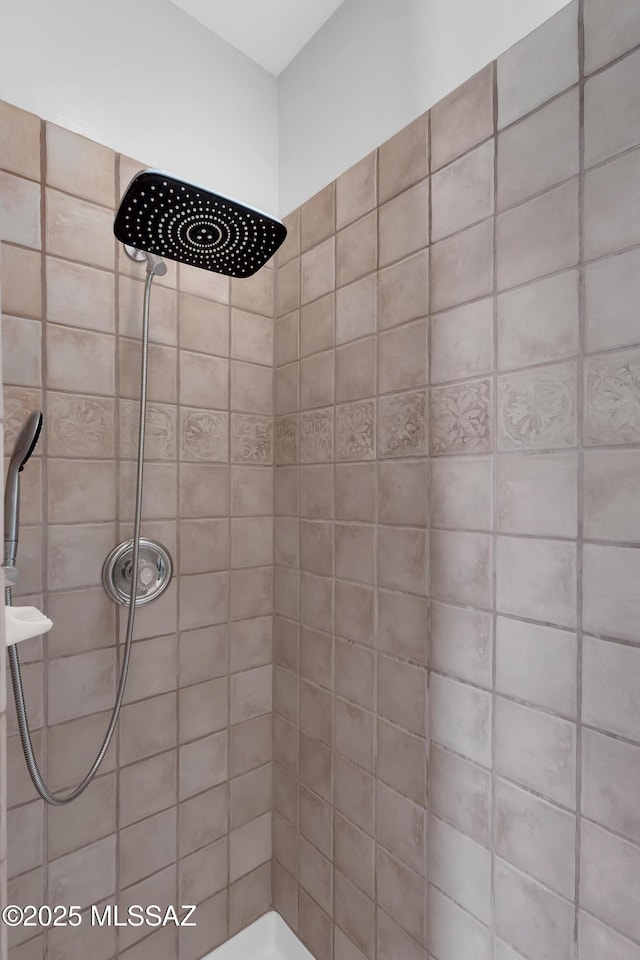 full bath with a tile shower