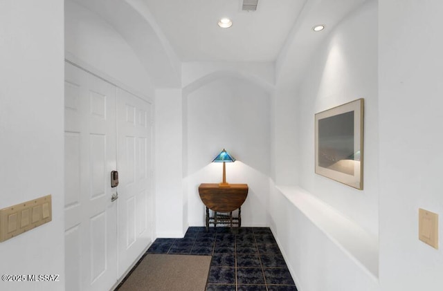 hall featuring recessed lighting and visible vents