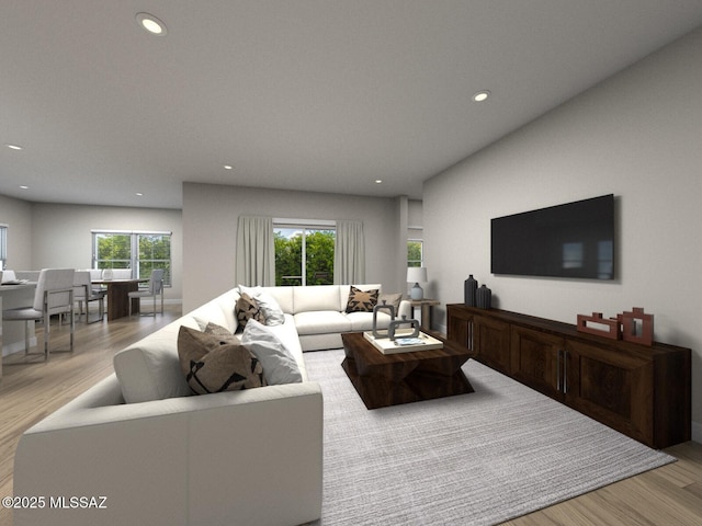 living area with light wood-style floors, plenty of natural light, and recessed lighting