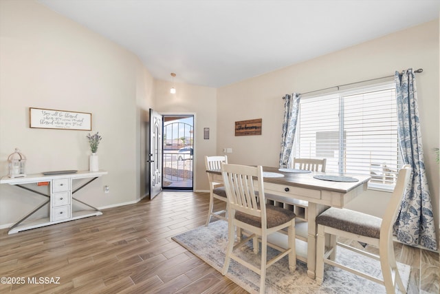 dining room featuring baseboards and wood finished floors