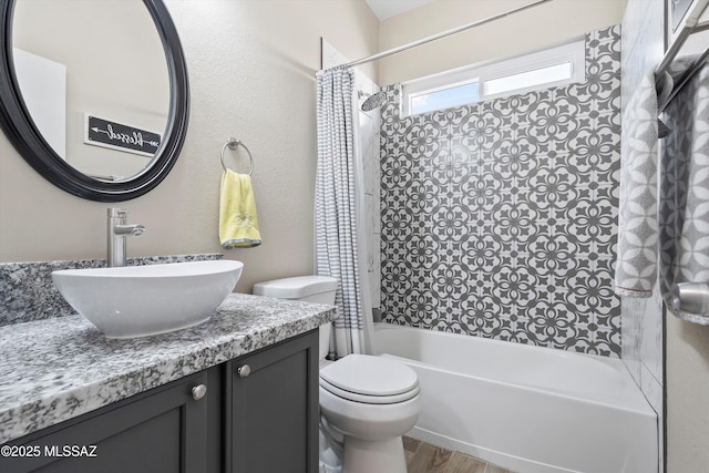 full bathroom featuring shower / tub combo, toilet, vanity, and wood finished floors