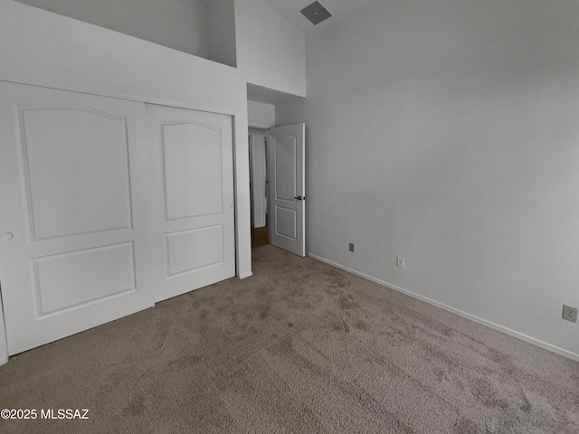 unfurnished bedroom with visible vents, baseboards, carpet flooring, and a closet