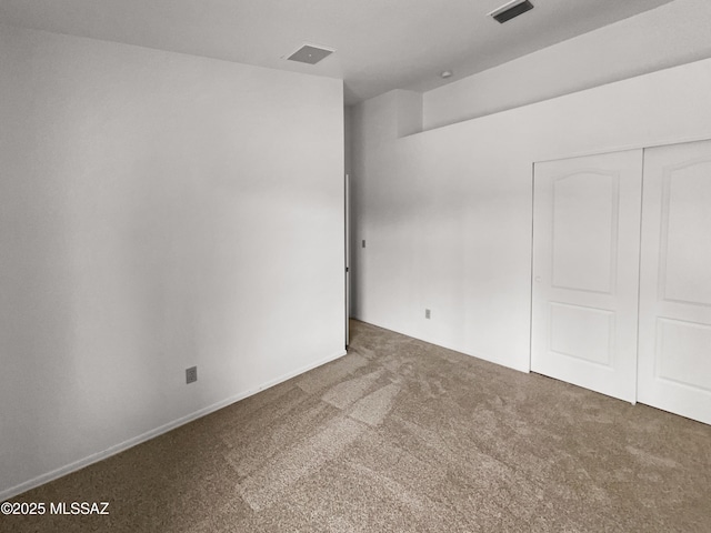 unfurnished room featuring carpet flooring and visible vents