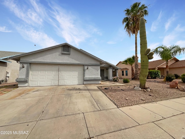 ranch-style house featuring driveway, stucco siding, and a garage