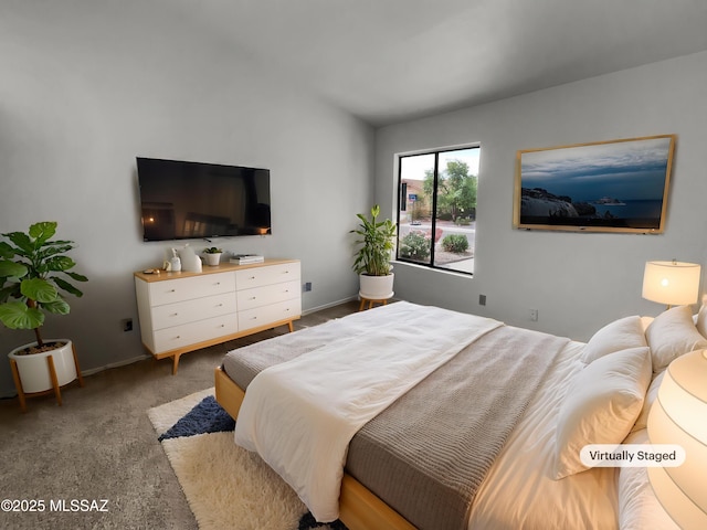 bedroom with baseboards, carpet, and vaulted ceiling