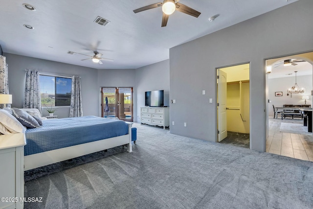 carpeted bedroom featuring multiple windows, a ceiling fan, access to exterior, and visible vents