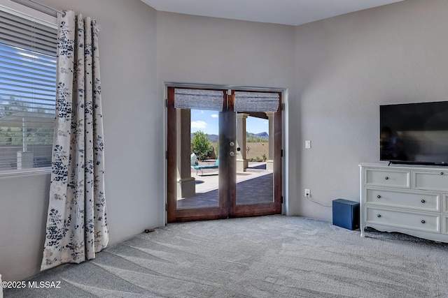 interior space with carpet floors and french doors