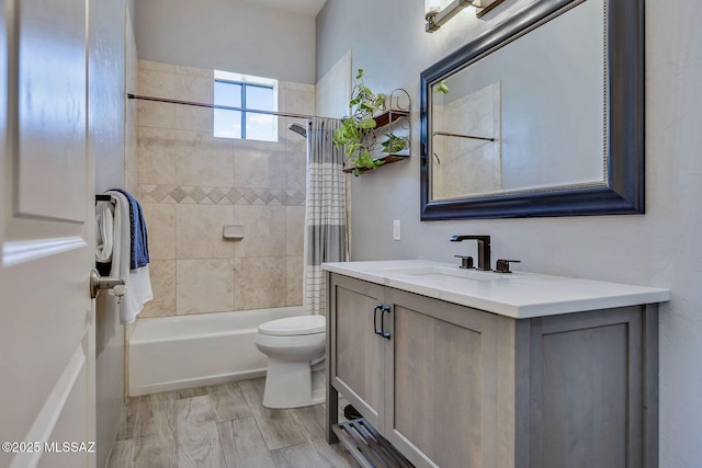 bathroom featuring toilet, shower / bathtub combination with curtain, wood finished floors, and vanity